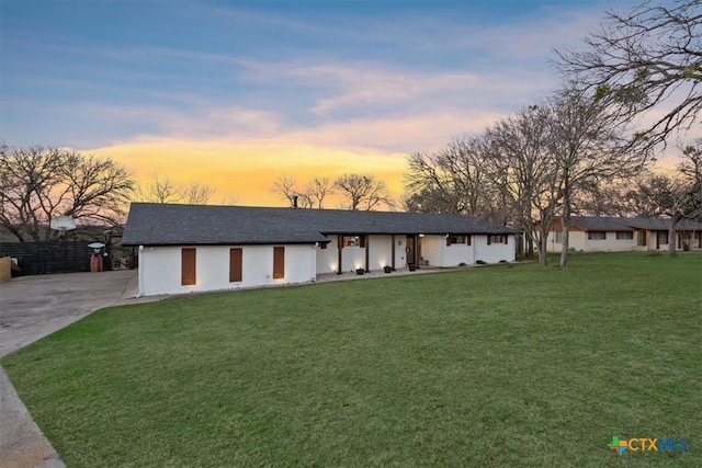 ranch-style home featuring a yard