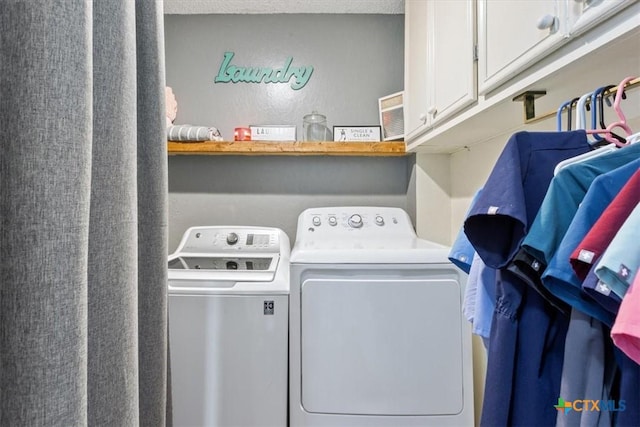 clothes washing area featuring cabinets and independent washer and dryer