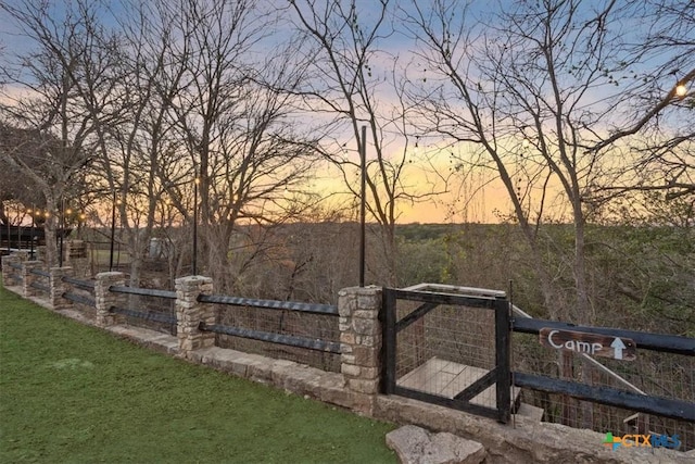 view of gate at dusk