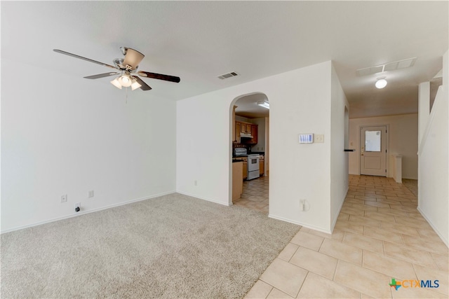 unfurnished room featuring ceiling fan and light colored carpet