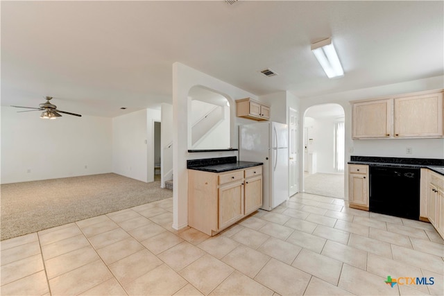 kitchen with ceiling fan, black dishwasher, light brown cabinetry, white fridge, and light colored carpet