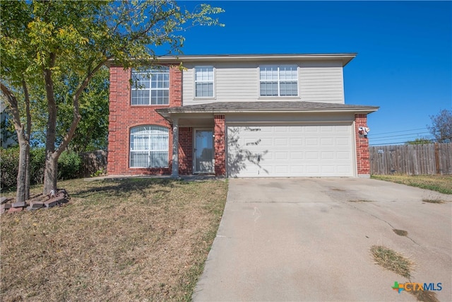 view of property featuring a front lawn and a garage