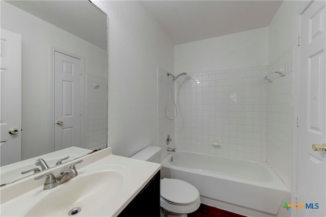 full bathroom with vanity, toilet, and tiled shower / bath