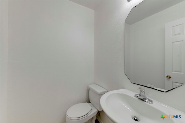 bathroom featuring sink and toilet