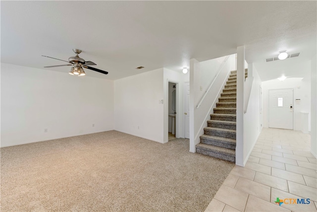 unfurnished living room with ceiling fan and light tile patterned floors