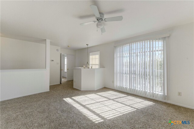 carpeted empty room with ceiling fan