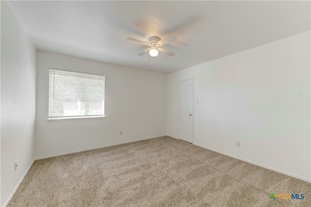 empty room featuring light carpet and ceiling fan