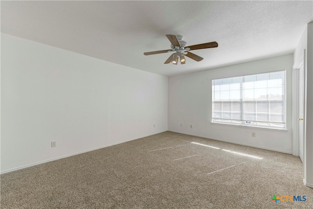 empty room with carpet, ceiling fan, and a textured ceiling