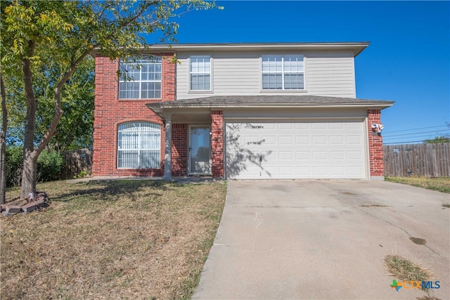 view of property with a front yard and a garage