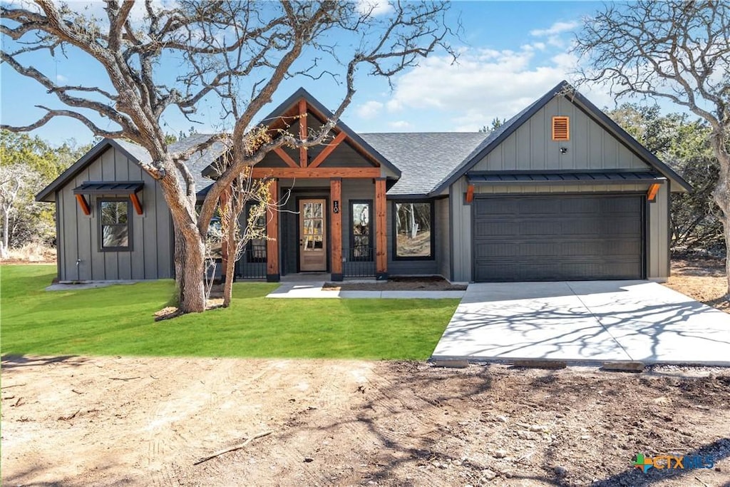 view of front of home with a garage and a front yard