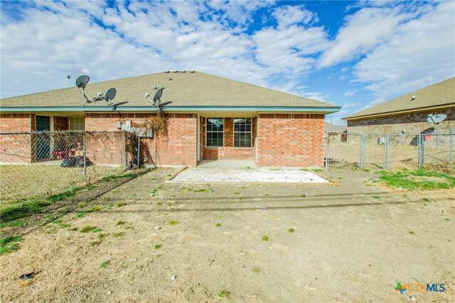 3504 Littleleaf Dr, Killeen, TX 76549 - rear view of house with fence, a gate, brick siding, and a patio area