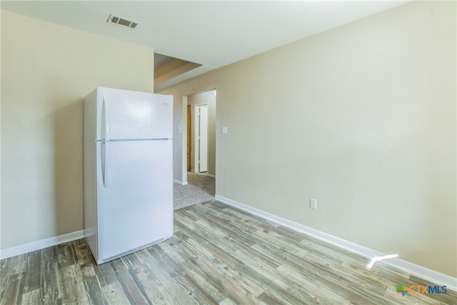 kitchen with light hardwood / wood-style flooring and white refrigerator