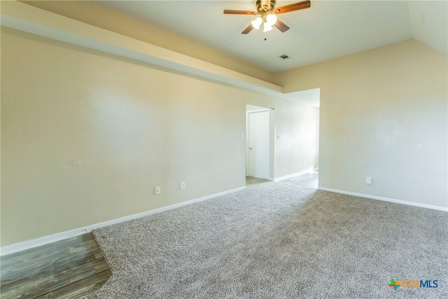 empty room with lofted ceiling, hardwood / wood-style floors, and ceiling fan