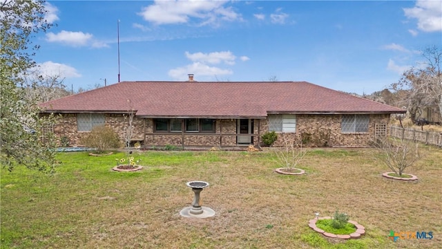 ranch-style home with a front lawn