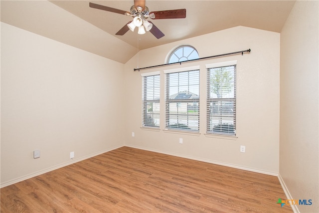 empty room featuring light hardwood / wood-style floors, ceiling fan, and vaulted ceiling