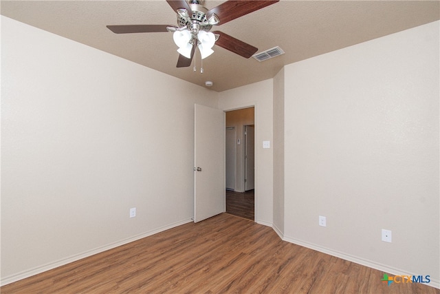 spare room with hardwood / wood-style flooring and ceiling fan