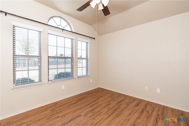 spare room featuring lofted ceiling, hardwood / wood-style floors, and ceiling fan