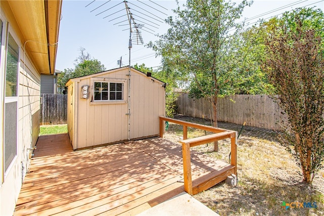 wooden terrace featuring a shed