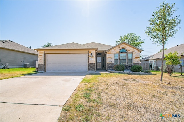 single story home featuring a front lawn, central air condition unit, and a garage