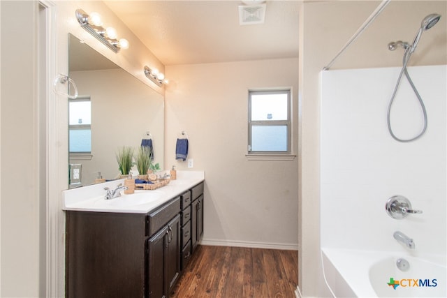 bathroom with vanity, hardwood / wood-style flooring, and tub / shower combination