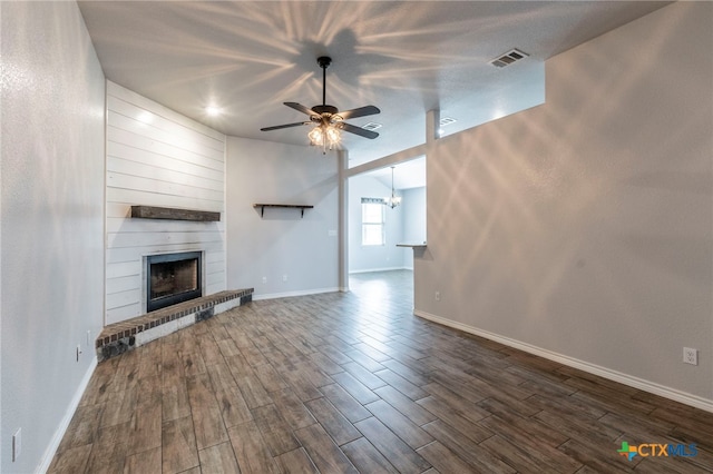 8530 Lamplight Ct, Temple, TX 76502 - unfurnished living room with a ceiling fan, a large fireplace, and dark wood-style flooring
