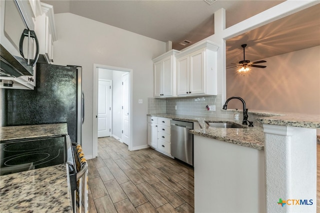 8530 Lamplight Ct, Temple, TX 76502 - kitchen with appliances with stainless steel finishes, white cabinetry, a ceiling fan, a peninsula, and wood finished floors