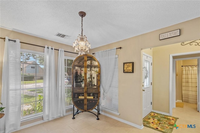 503 Ashland Crk, Victoria, TX 77901 - dining room with a chandelier, a textured ceiling, and light tile patterned flooring