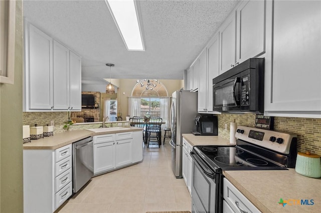 503 Ashland Crk, Victoria, TX 77901 - kitchen featuring appliances with stainless steel finishes, light countertops, white cabinets, light tile patterned floors, and tasteful backsplash
