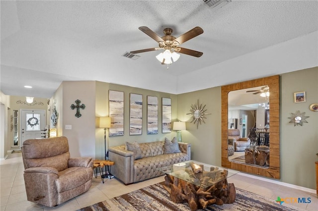 503 Ashland Crk, Victoria, TX 77901 - tiled living room featuring ceiling fan, a textured ceiling, and arched walkways