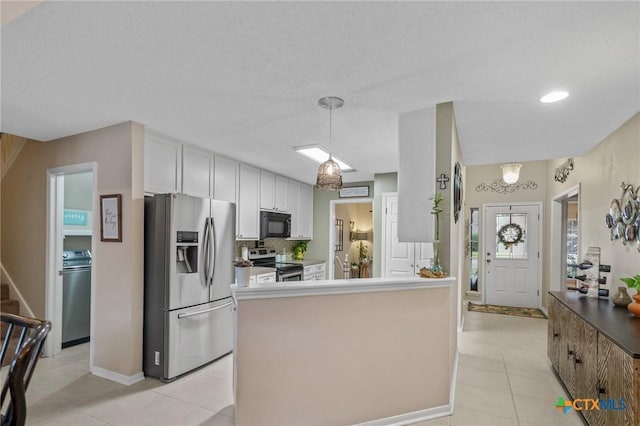 503 Ashland Crk, Victoria, TX 77901 - kitchen with stainless steel appliances, light tile patterned floors, white cabinetry, tasteful backsplash, and decorative light fixtures