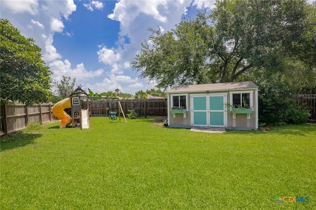 503 Ashland Crk, Victoria, TX 77901 - fenced backyard featuring a storage shed and a playground