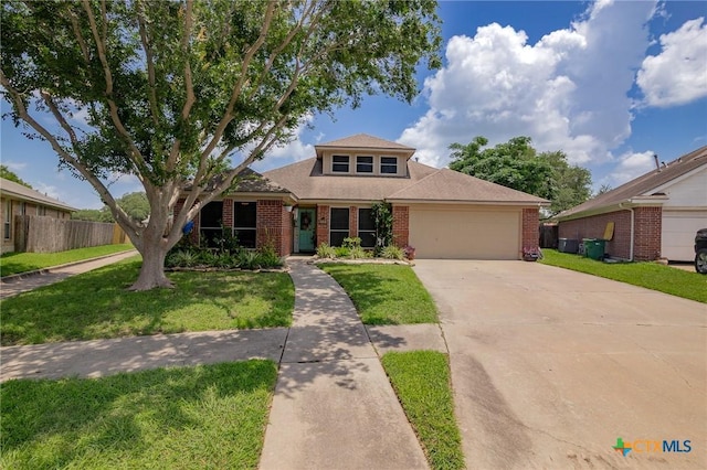 503 Ashland Crk, Victoria, TX 77901 - view of front of property with brick siding, a garage, driveway, and roof with shingles
