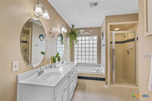 503 Ashland Crk, Victoria, TX 77901 - full bath with a shower stall, double vanity, a bath, tile patterned floors, and a textured ceiling