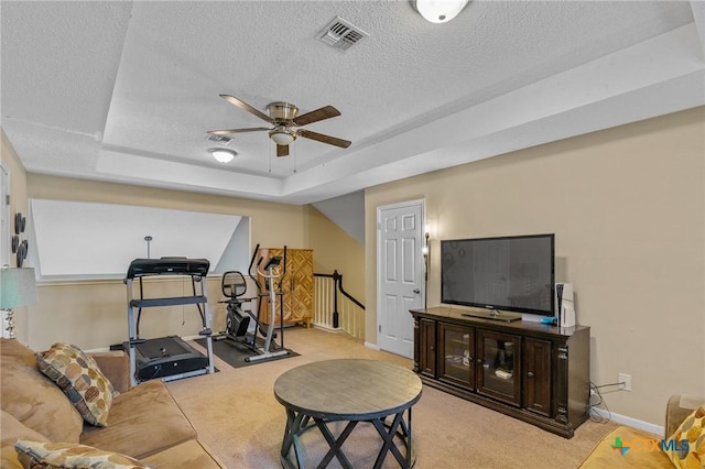 503 Ashland Crk, Victoria, TX 77901 - workout area featuring a ceiling fan, carpet, a textured ceiling, and a raised ceiling