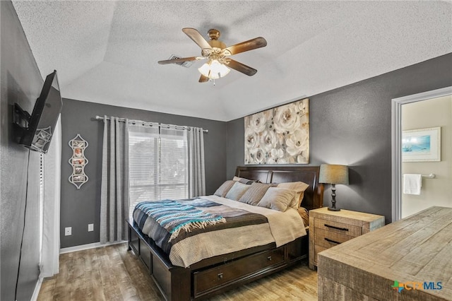 503 Ashland Crk, Victoria, TX 77901 - bedroom with wood finished floors, lofted ceiling, a textured ceiling, and ceiling fan