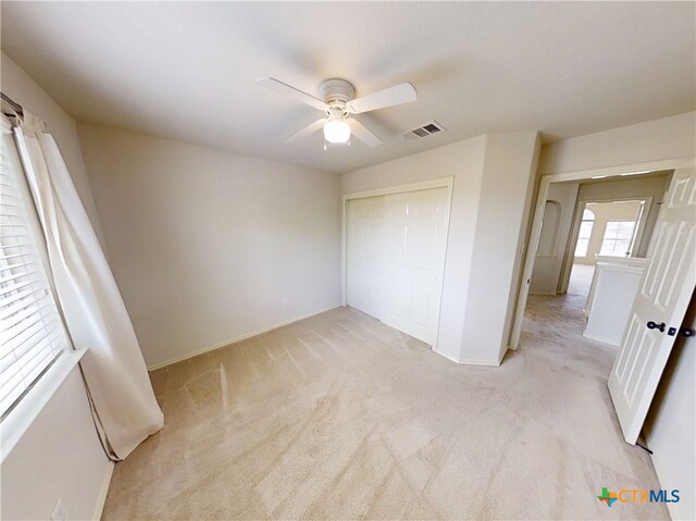 7016 Brandon Dr, Temple, TX 76502 - unfurnished bedroom featuring light carpet, a closet, and ceiling fan