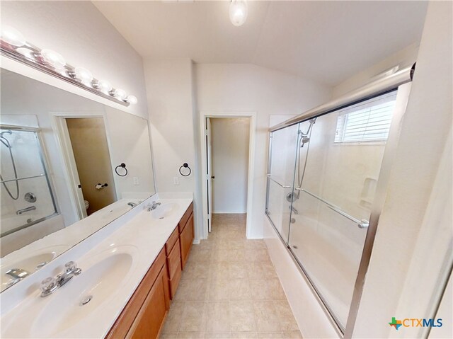 7016 Brandon Dr, Temple, TX 76502 - full bathroom with lofted ceiling, shower / bath combination with glass door, double vanity, and tile patterned flooring