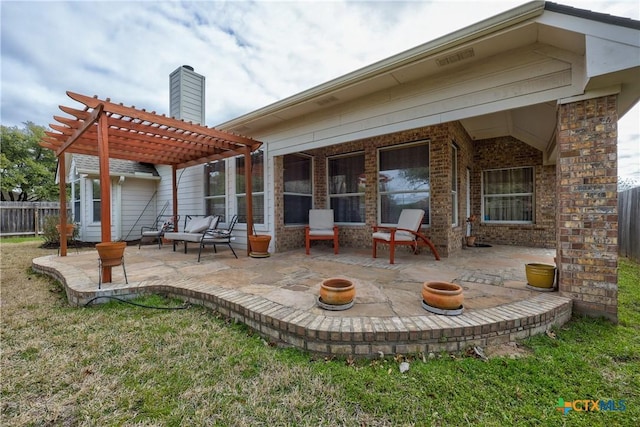 rear view of property with brick siding, fence, an outdoor fire pit, a patio area, and a pergola