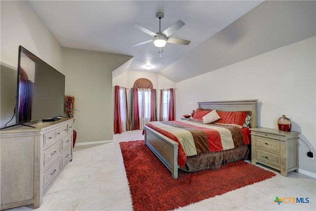 bedroom with a ceiling fan, baseboards, and vaulted ceiling