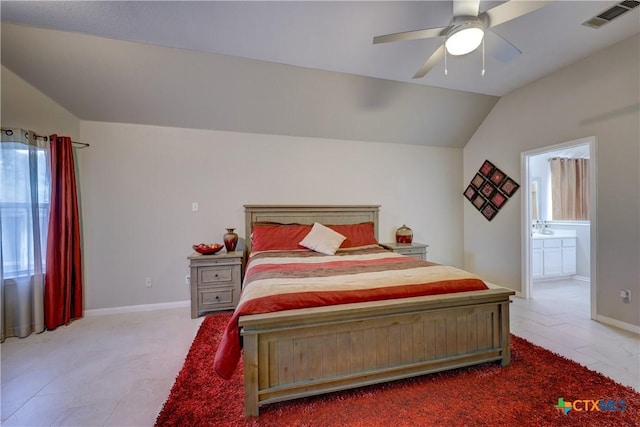 carpeted bedroom with visible vents, connected bathroom, baseboards, and vaulted ceiling