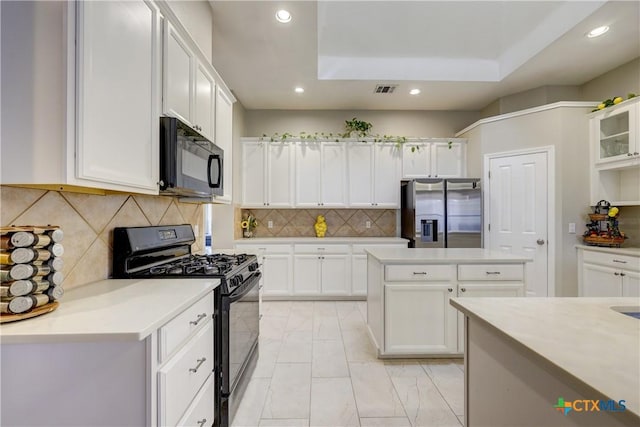 kitchen featuring white cabinetry and black appliances