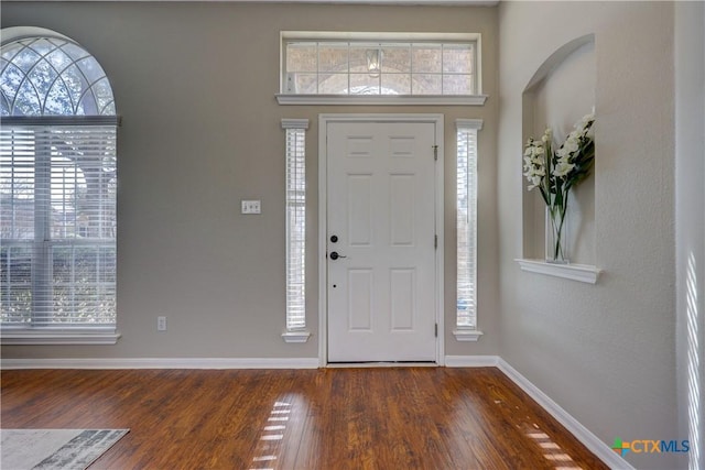 entrance foyer with wood finished floors and baseboards