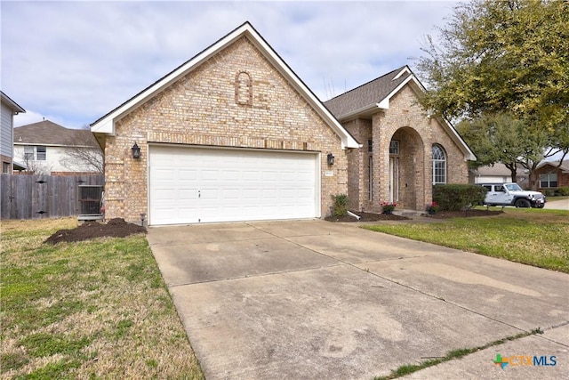 view of front of property with a garage, brick siding, concrete driveway, and fence