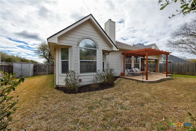 back of property with a chimney, a yard, a fenced backyard, a patio area, and a pergola