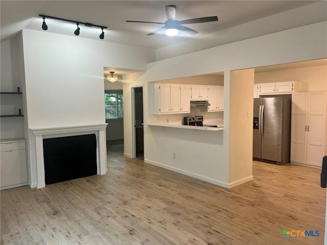 836 Mica Ln, Leander, TX 78641 - kitchen featuring stainless steel fridge, a ceiling fan, track lighting, under cabinet range hood, and light countertops