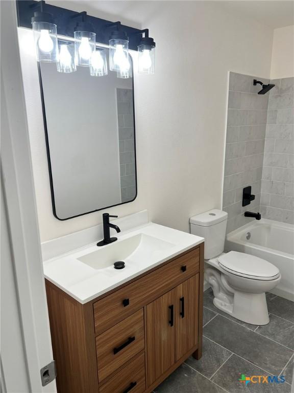 836 Mica Ln, Leander, TX 78641 - bathroom with vanity, toilet, washtub / shower combination, and tile patterned flooring