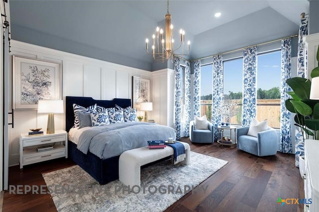 bedroom featuring lofted ceiling, a notable chandelier, and dark wood finished floors