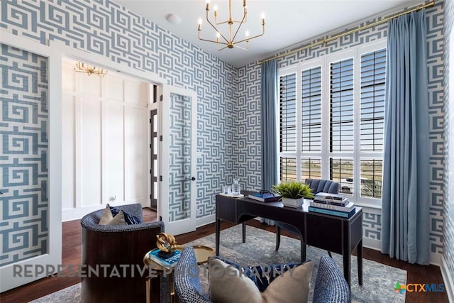 office area with baseboards, an inviting chandelier, wood finished floors, and wallpapered walls