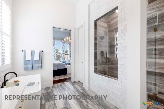 ensuite bathroom featuring ensuite bath, baseboards, and a stall shower