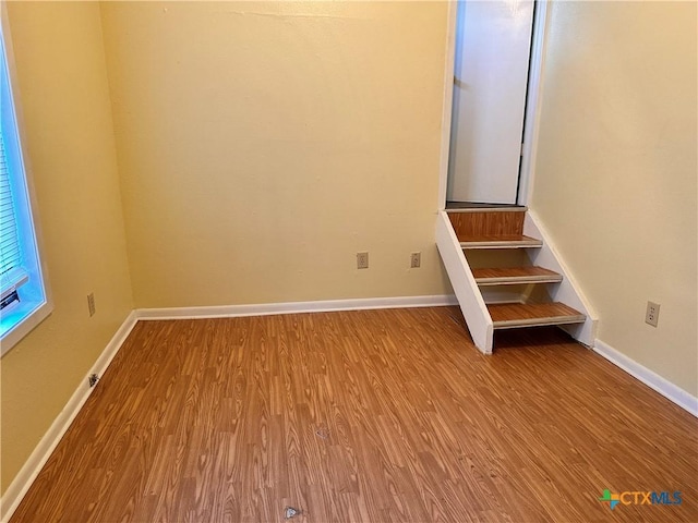 899/901 Hillyer St, San Marcos, TX 78666 - spare room featuring wood finished floors, baseboards, and stairway